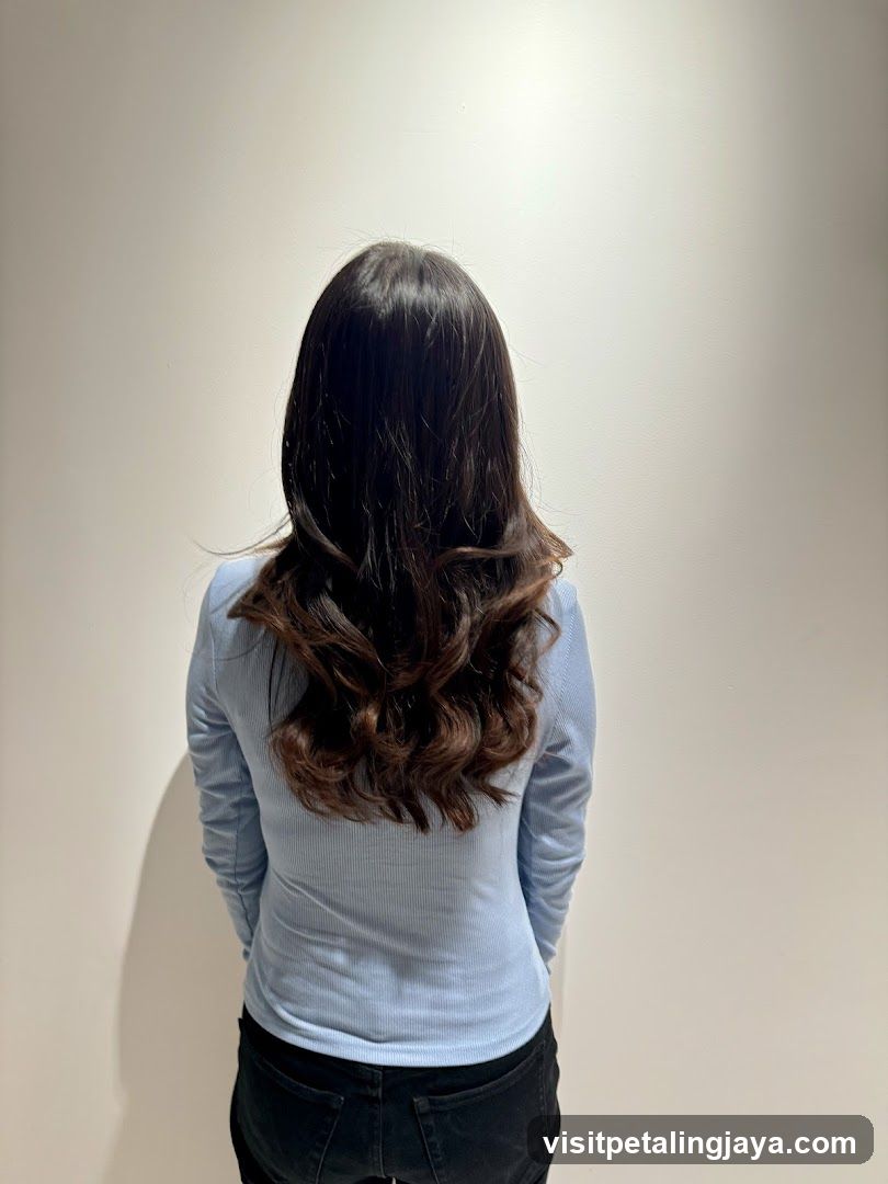 Back view of a person with long wavy hair