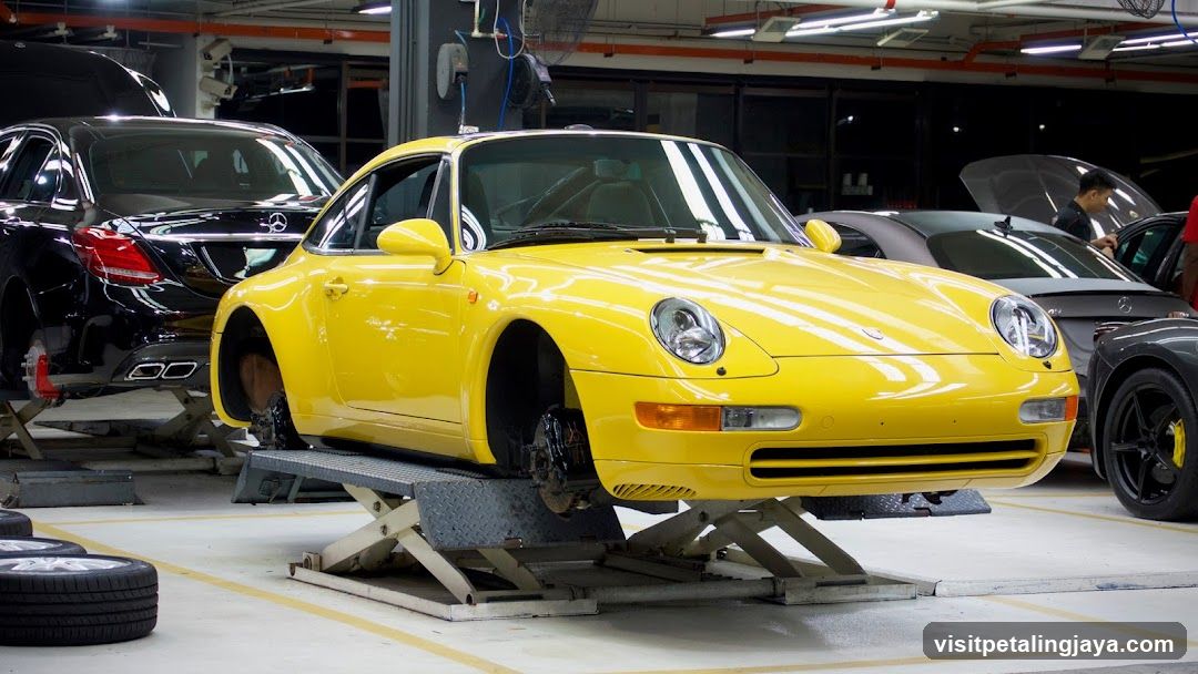 Yellow Porsche on Lift in Garage