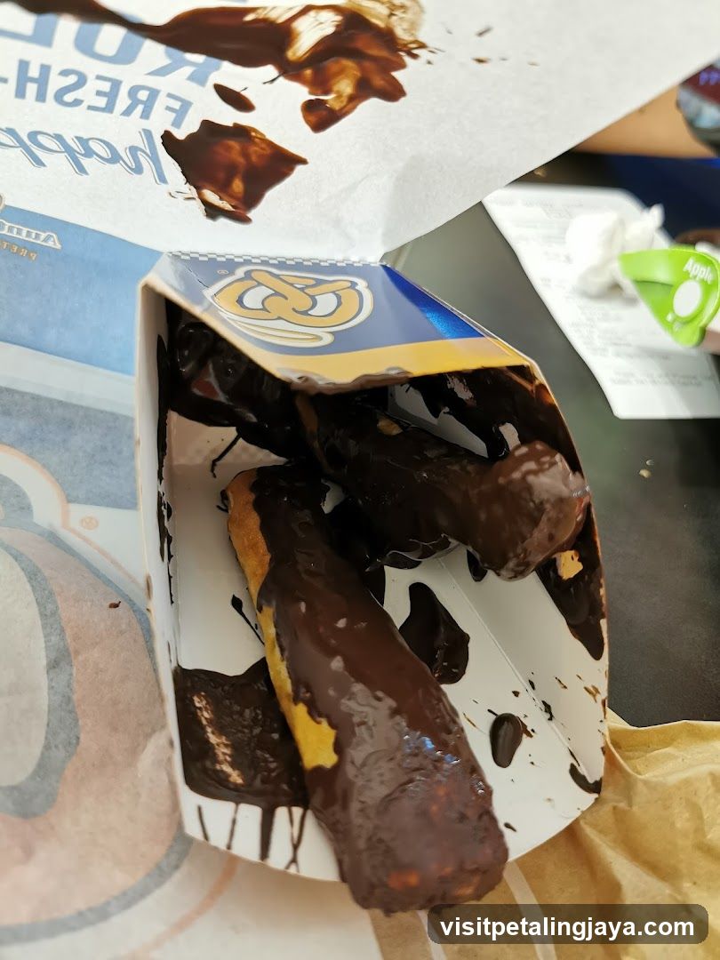 Chocolate-covered pretzel sticks in a box