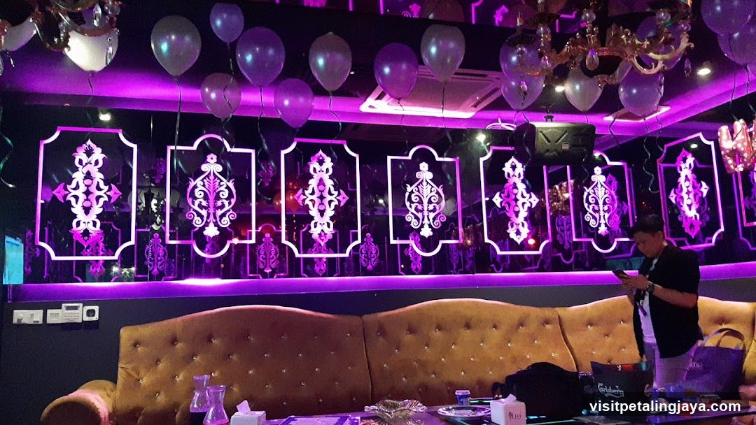 Purple-lit lounge interior with decorative wall panels and balloons