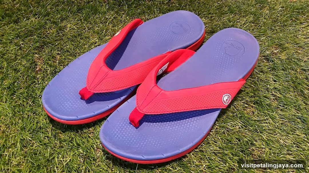 Red and Blue Flip Flops on Grass