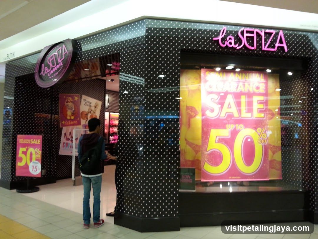 A storefront of La Senza featuring a semi-annual clearance sale sign with up to 50% off, visible signage on the building facade.