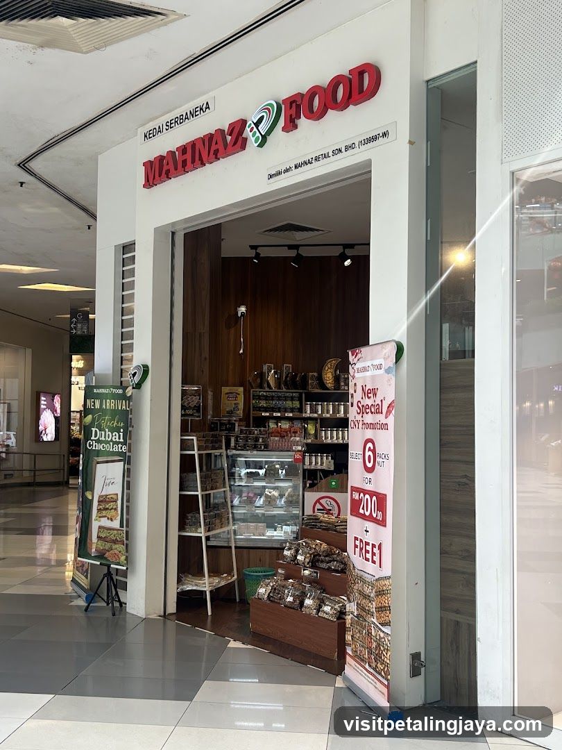 Exterior view of Mahnaz Food shop entrance with visible signage, glass display cases, and promotional posters outside.
