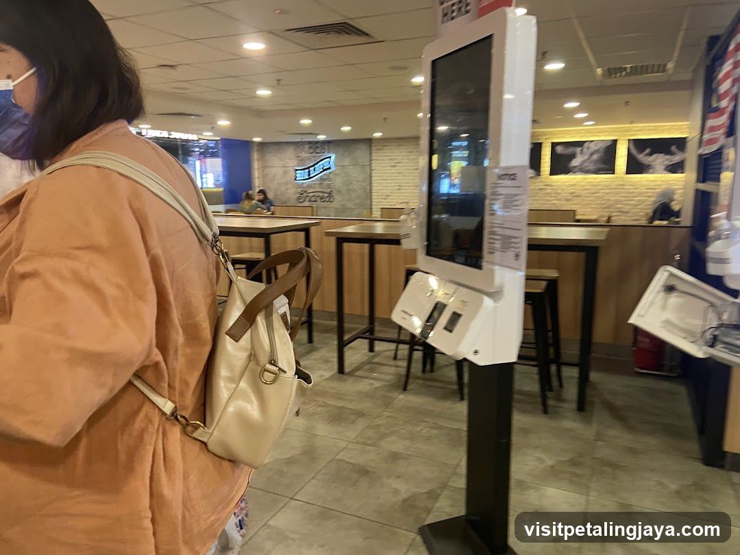 Interior of a food outlet with self-checkout kiosk