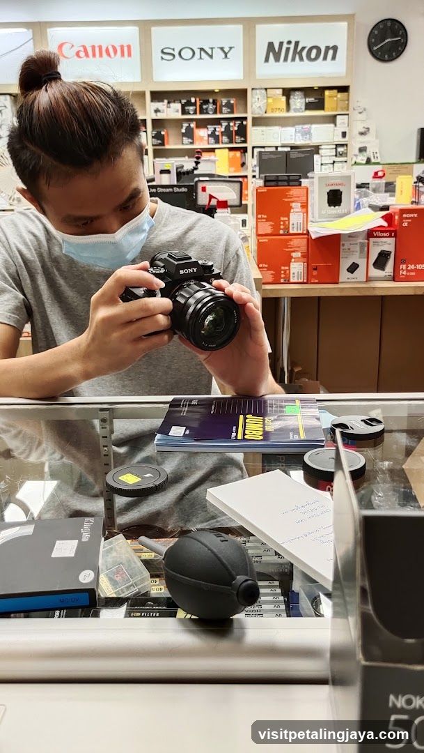 Person examining camera in electronics store