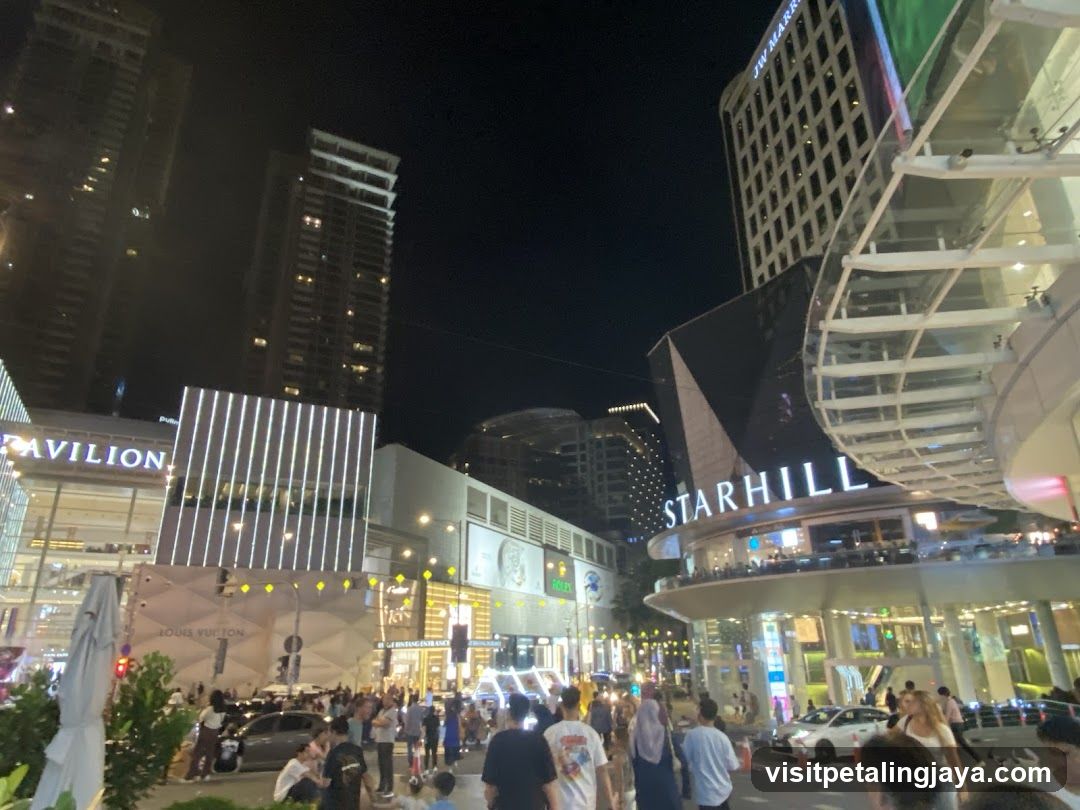 Night scene of shopping area with illuminated buildings and crowds