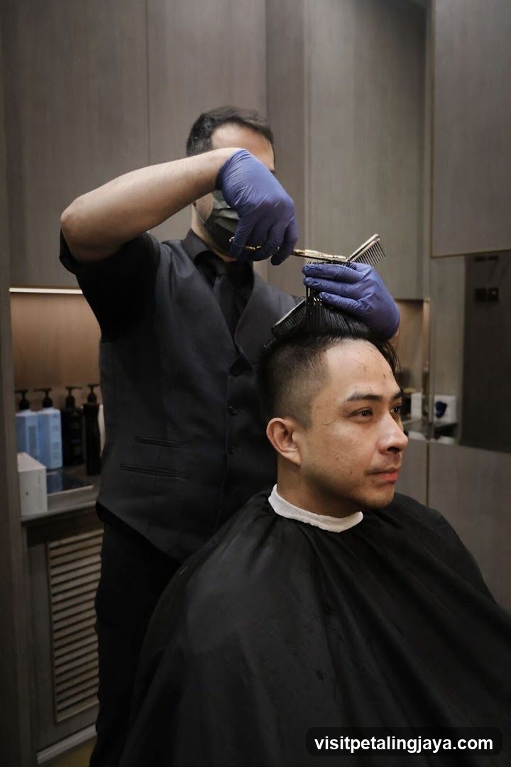 Barber cutting hair in salon