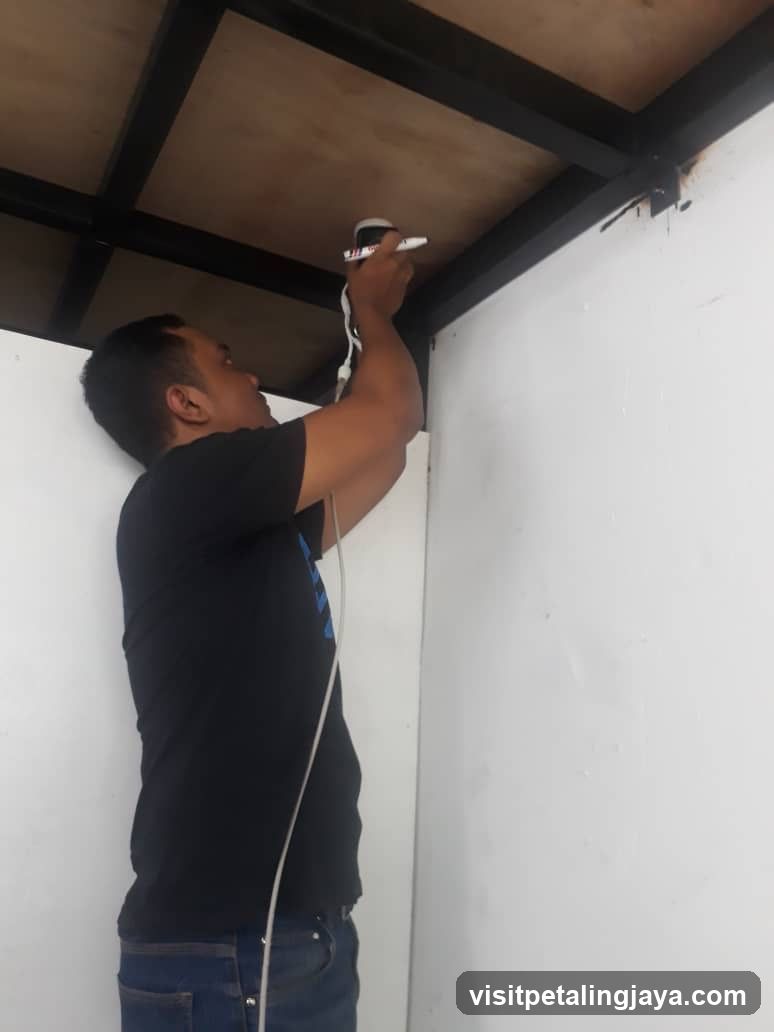 Worker Installing Ceiling Fixture