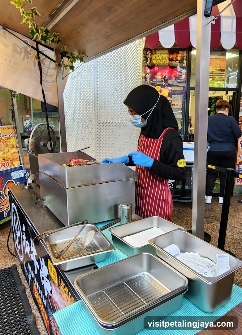 Food Stall with Staff Preparing Food