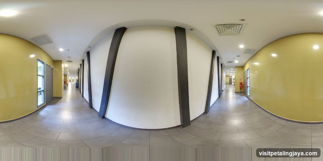 Interior Hallway with Yellow Walls and White Columns