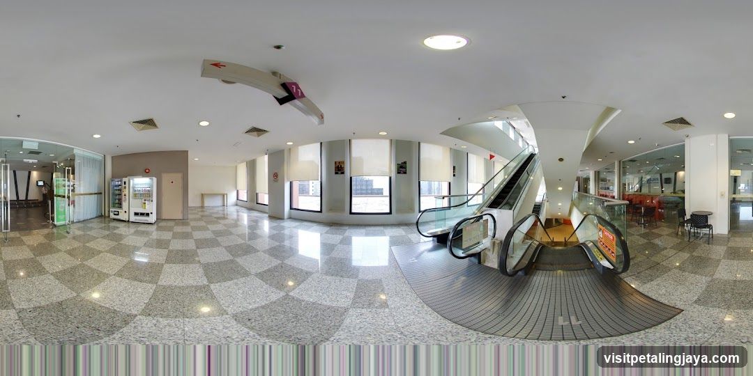 Interior of a modern building with escalators and vending machines
