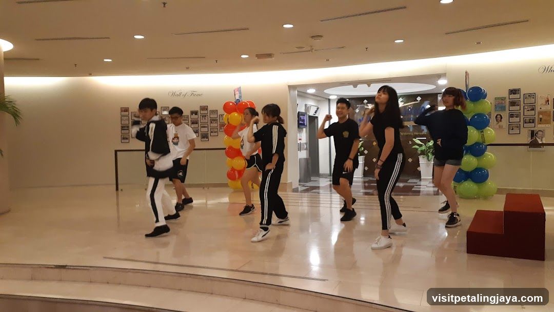 Group Dance Performance in Mall Lobby