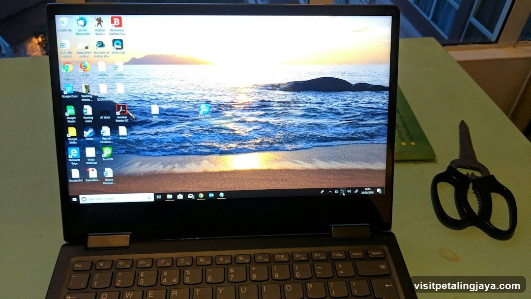 Laptop on desk with scissors nearby