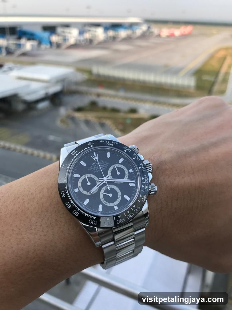 Watch on wrist overlooking airport