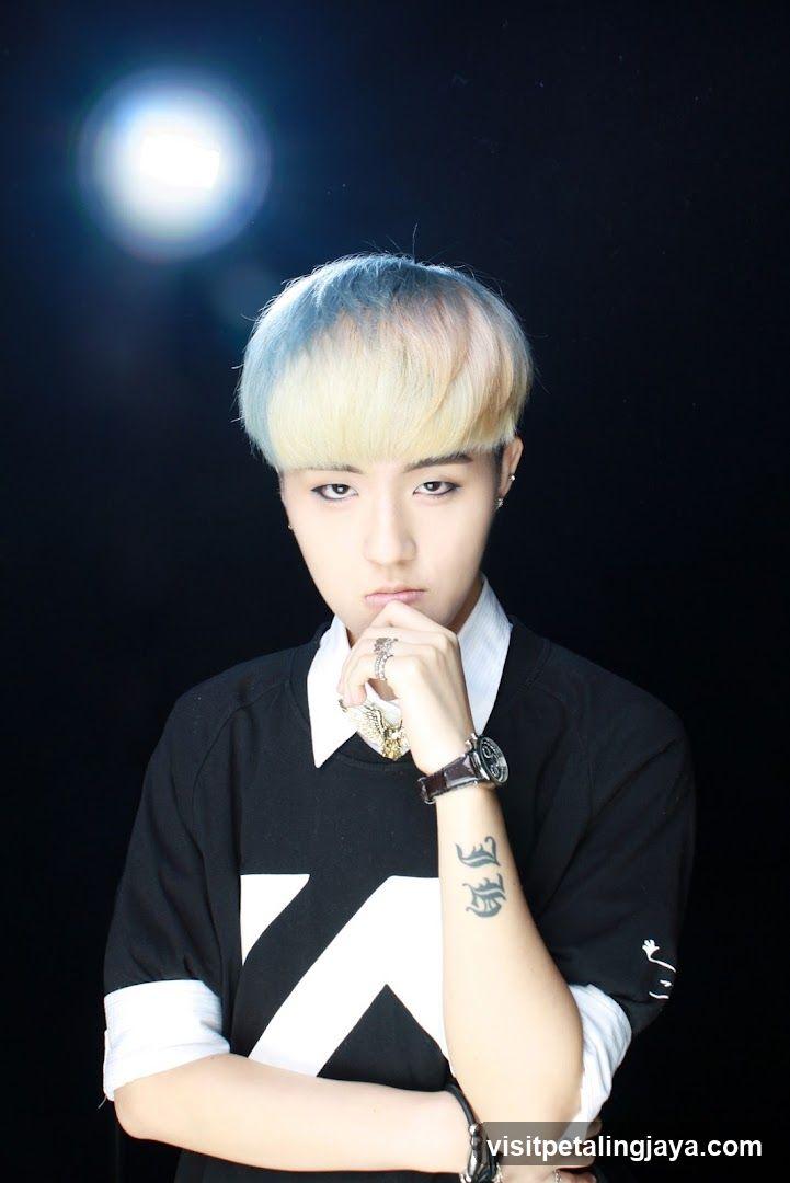 Portrait of a person with bleached hair and black shirt