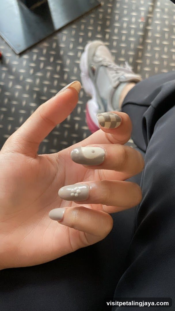 Hand with decorated nails and sneakers