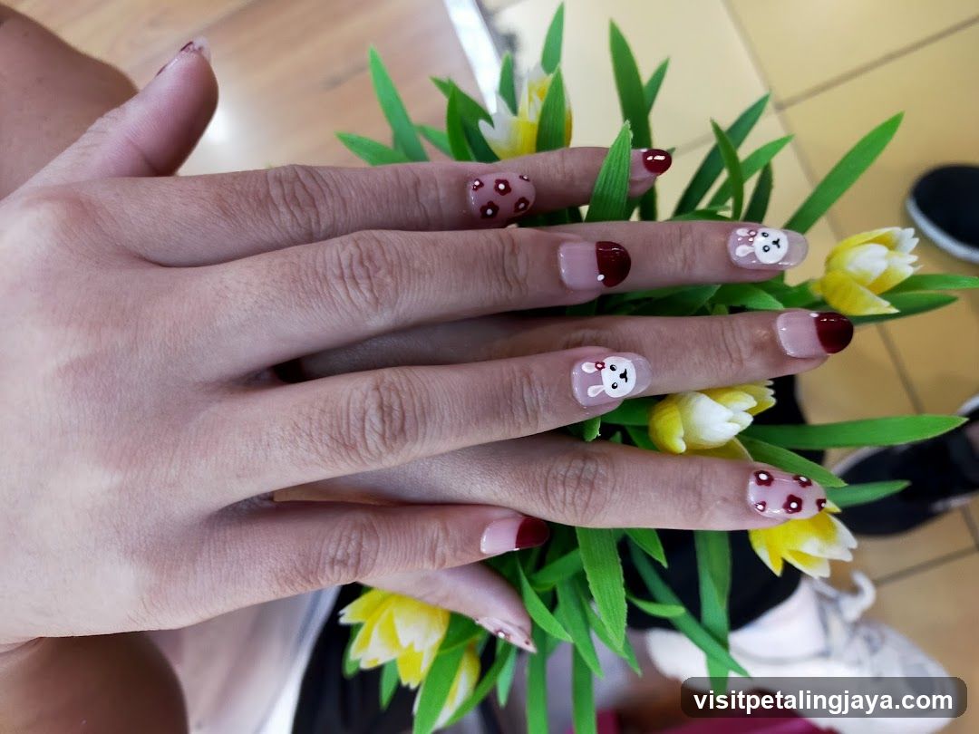 Hand with Cute Nail Art and Flowers