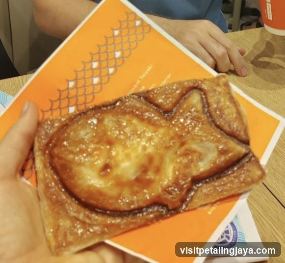 Cat-shaped pastry on orange card