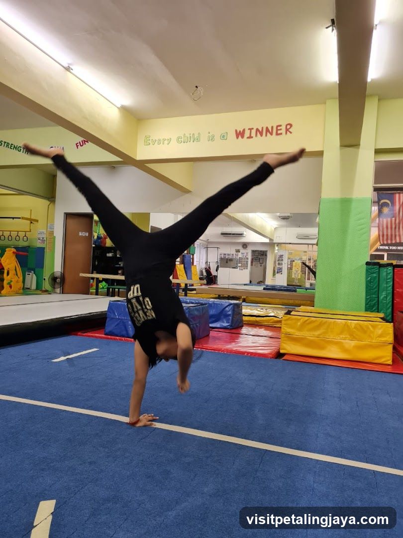 Gymnast performing handstand in indoor facility