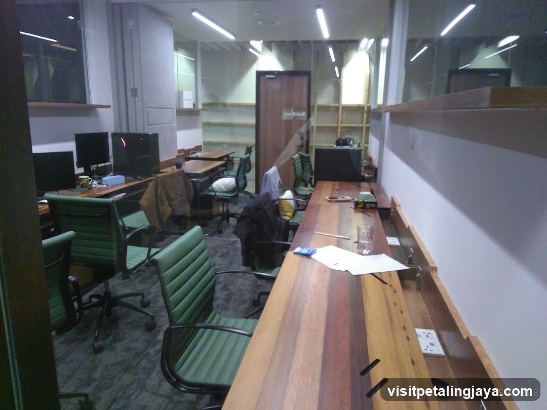 Office Interior with Green Chairs and Wooden Desks