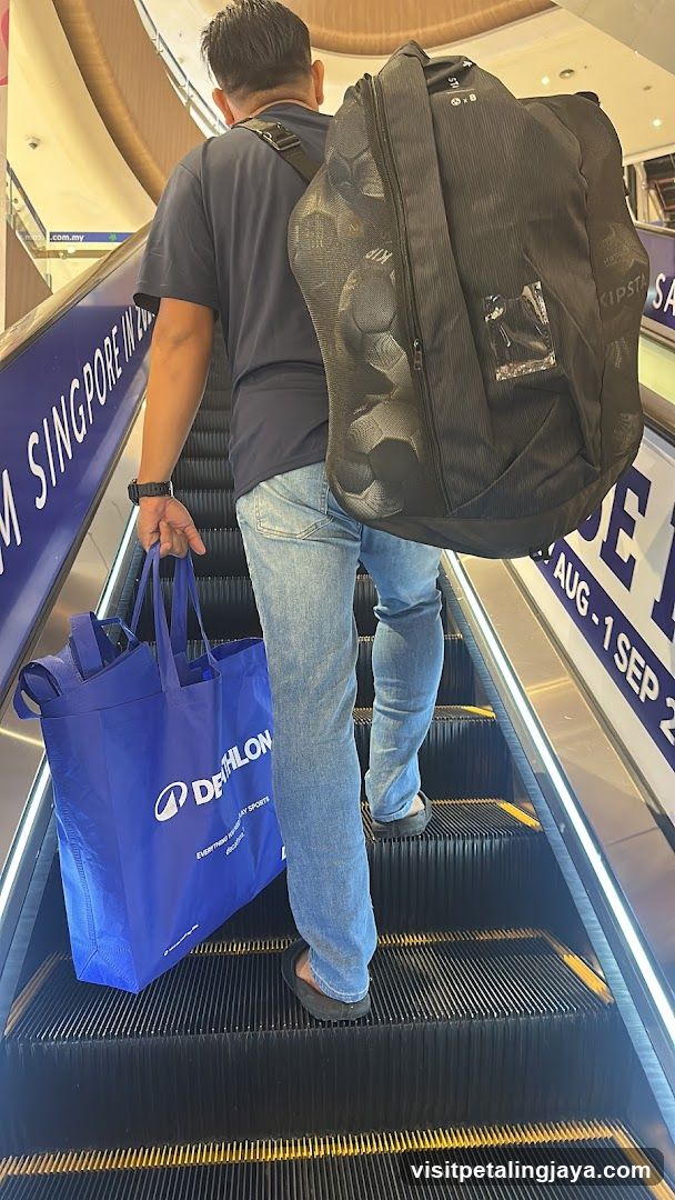 Man with bags on escalator