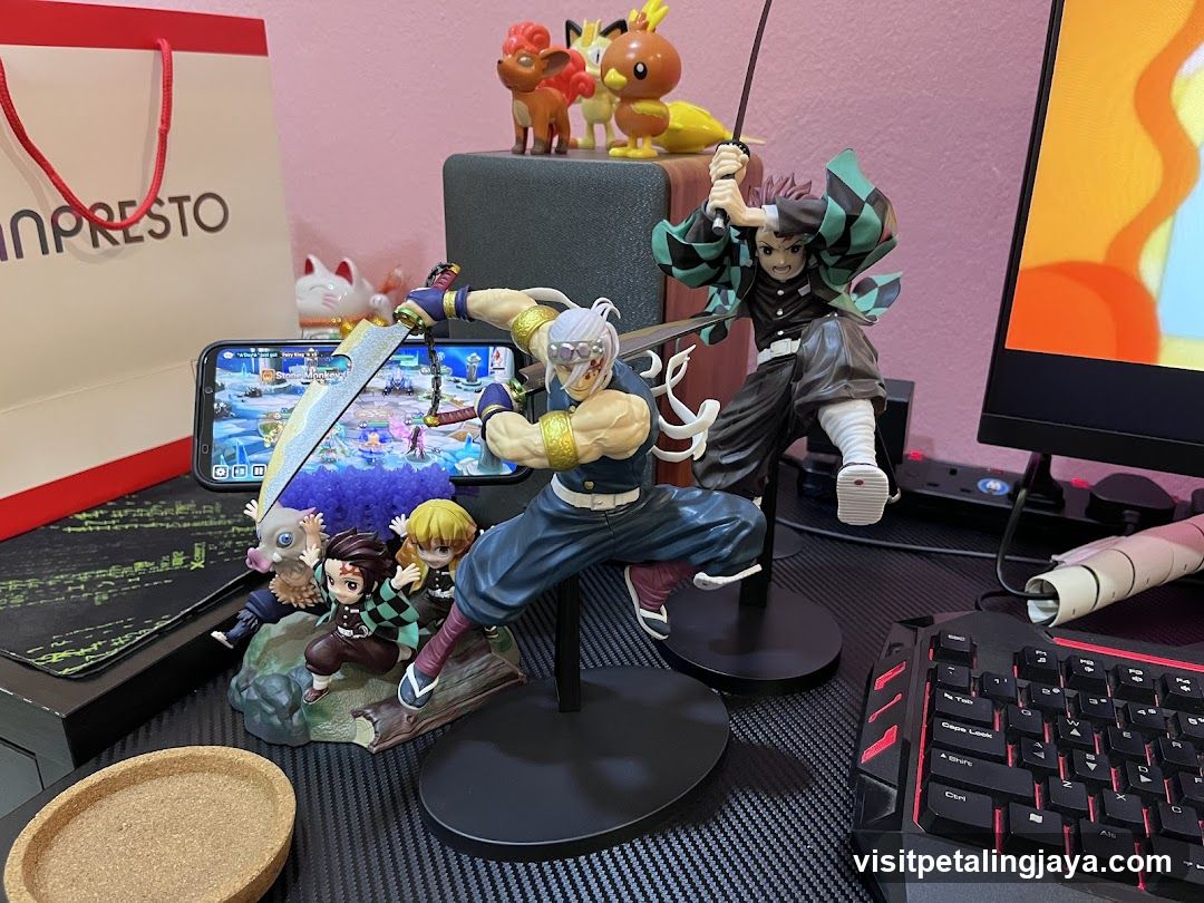 Demon Slayer and One Piece figurine display on desk