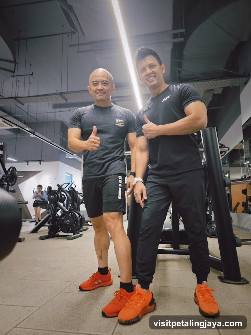 Gym Interior with Two Men Giving Thumbs Up