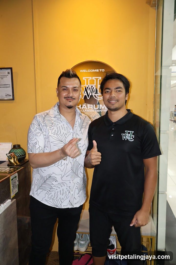 Two men posing in a wellness center lobby