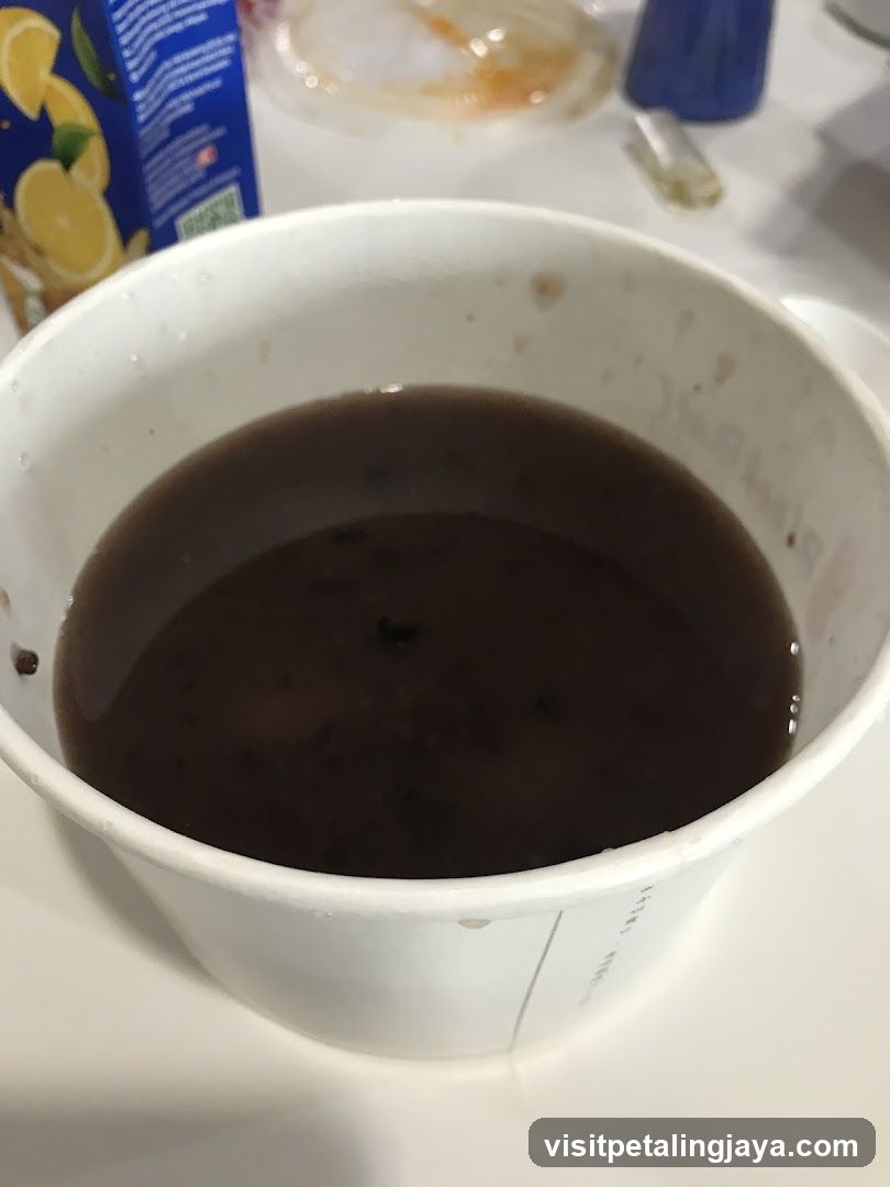Bowl of dark liquid in a disposable cup