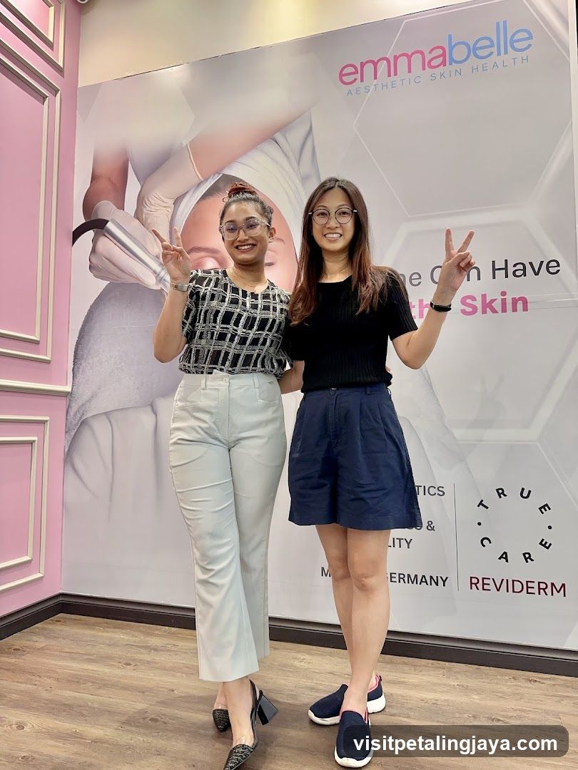 Two women posing in front of a beauty clinic wall