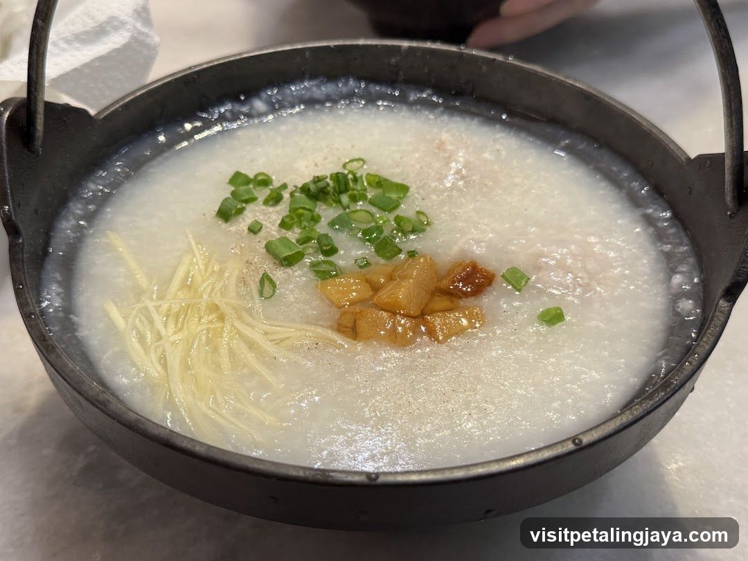 Congee with toppings in a metal bowl