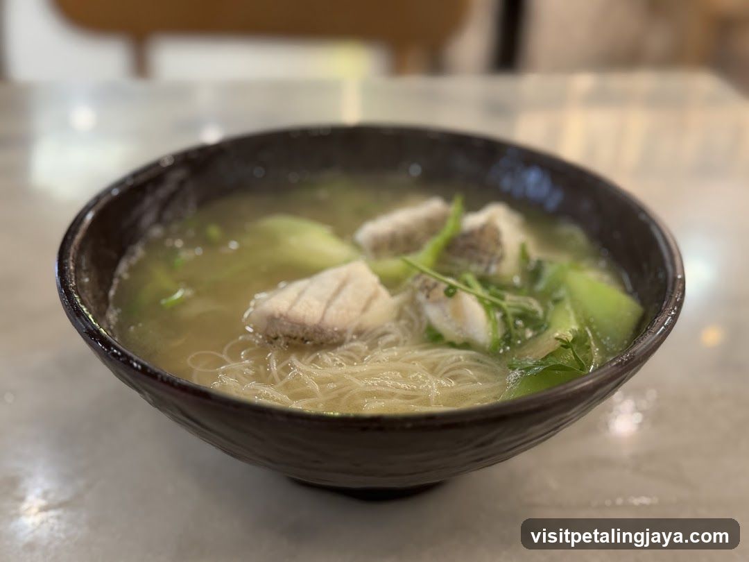 Bowl of Noodle Soup with Fish and Greens