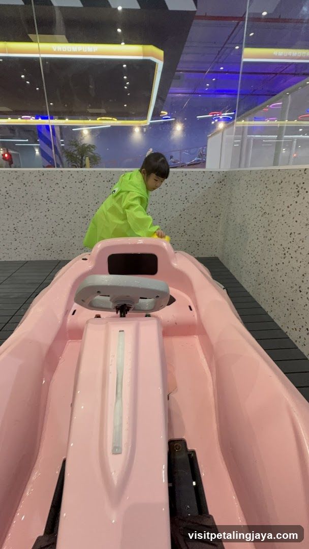 Child in Green Jacket at Indoor Water Park