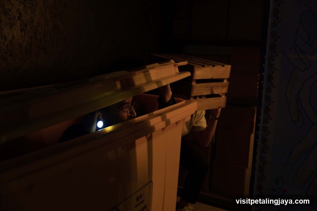 Person in dark room with flashlight