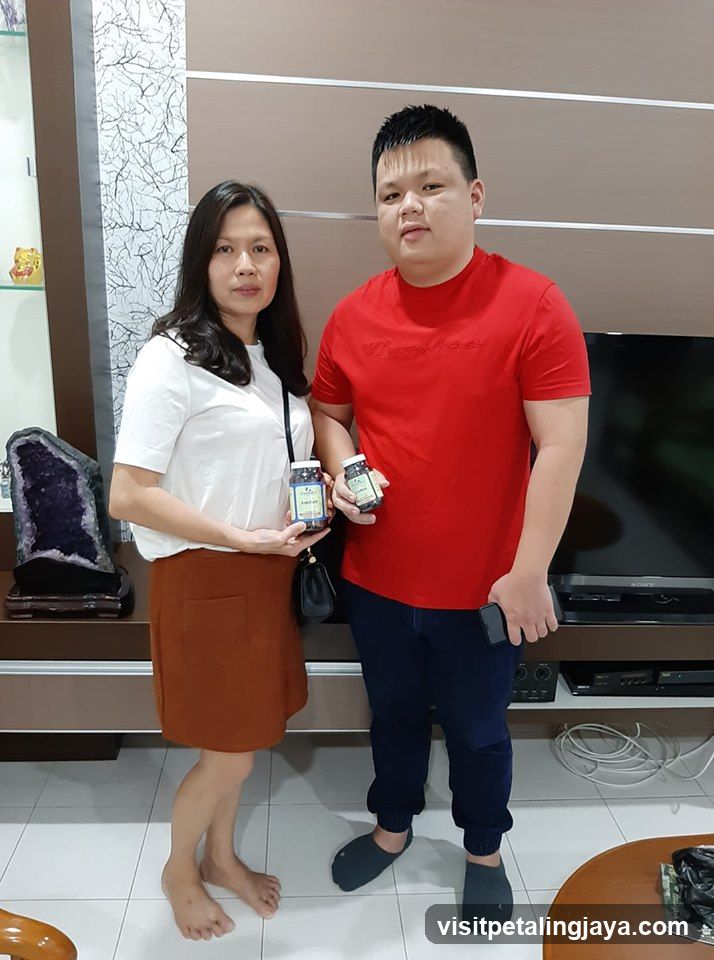 Couple Holding Product Jars Indoors