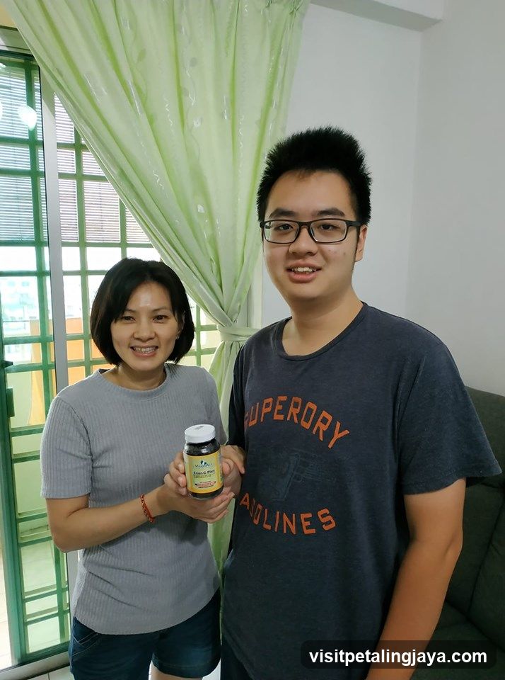 Two people holding a supplement bottle
