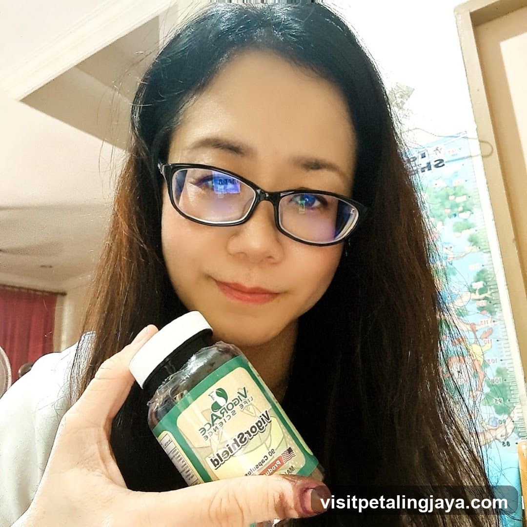 Woman holding supplement bottle