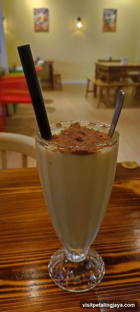 Cocoa Powder Milkshake with Straw and Spoon