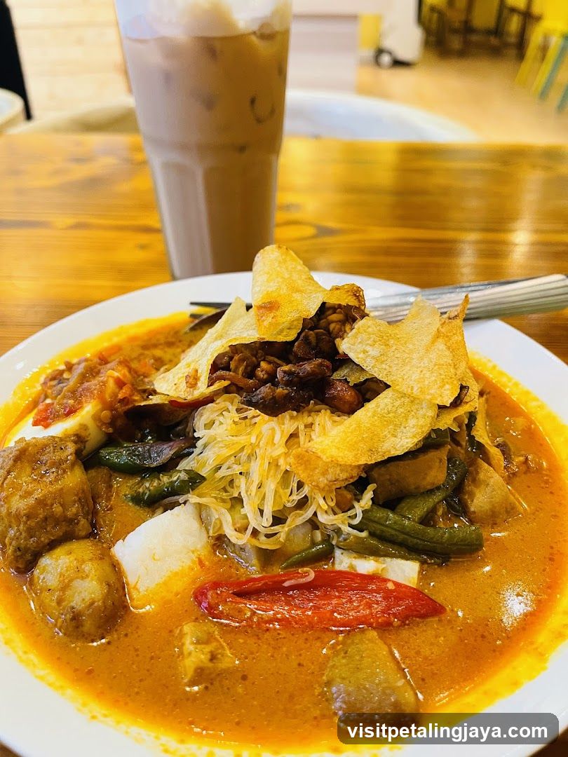 Curry Noodle Dish with Chips and Iced Drink