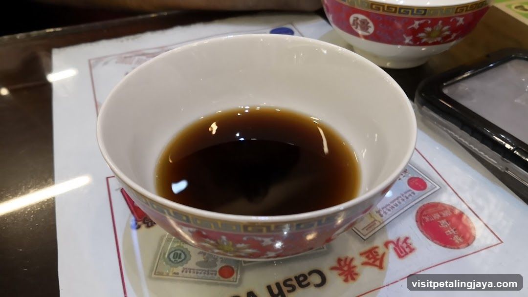 Bowl of Dark Liquid on Table