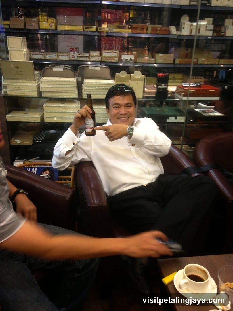 Man holding beer bottle in shop interior