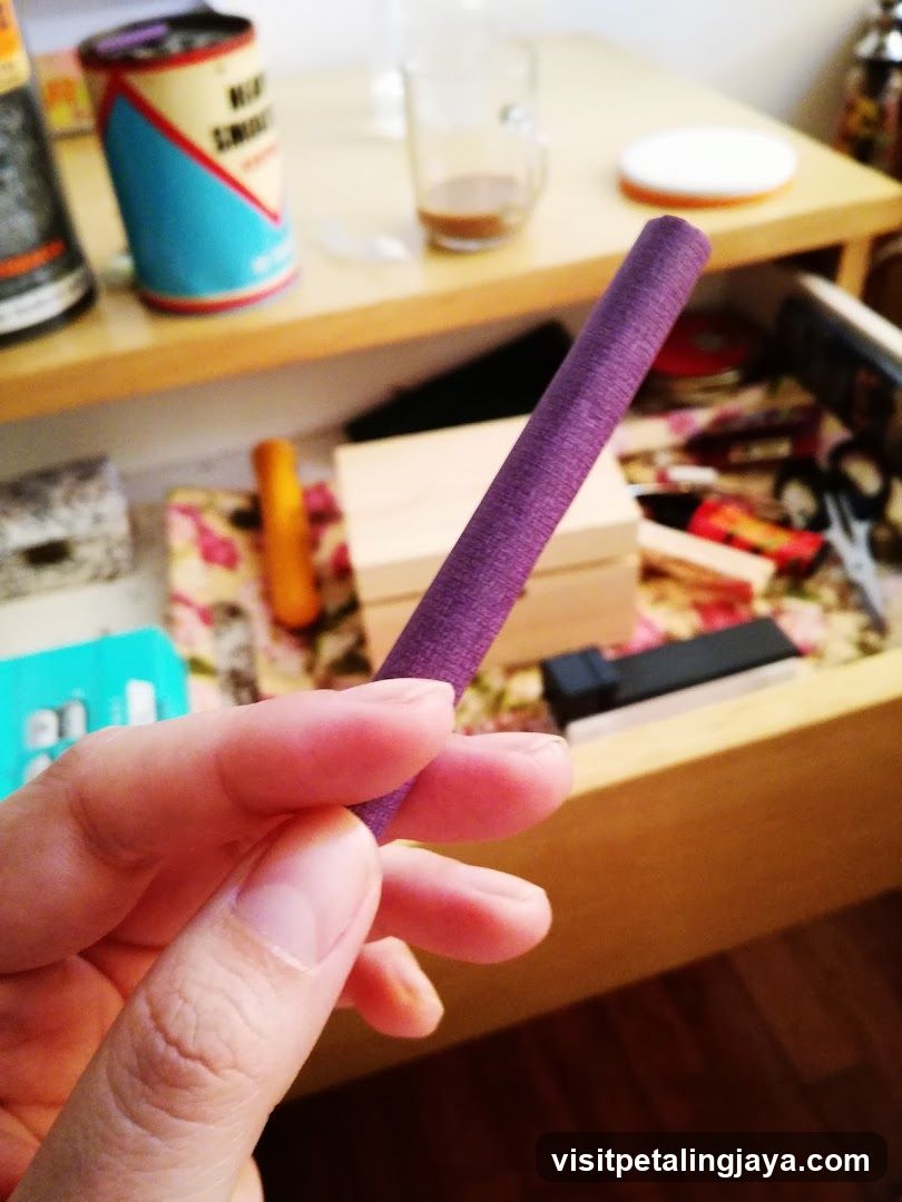 Purple Cylinder Held in Hand