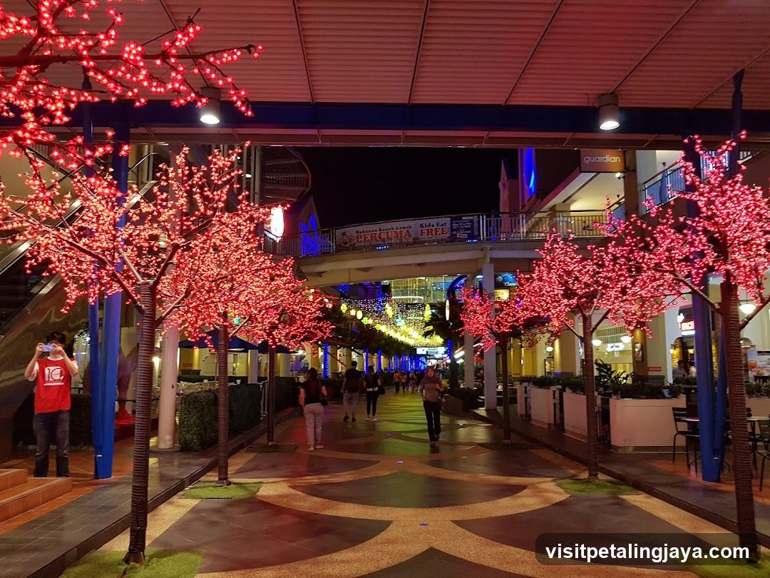 Nighttime Shopping Promenade with Decorative Trees