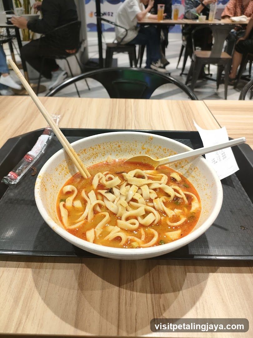 Bowl of Noodles with Chopsticks and Spoon