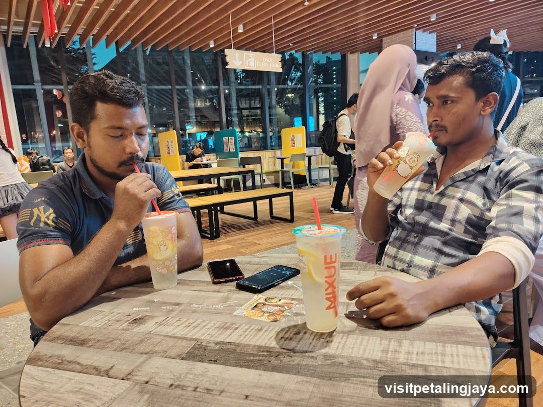 Two men drinking at a cafe table
