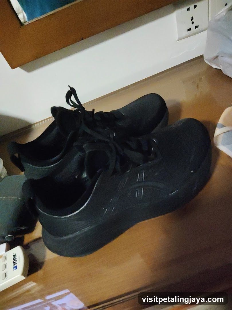 Black Athletic Shoes on Wooden Surface