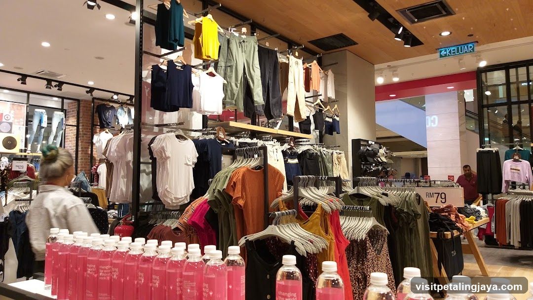 Clothing Store Interior with Pink Bottles in Foreground