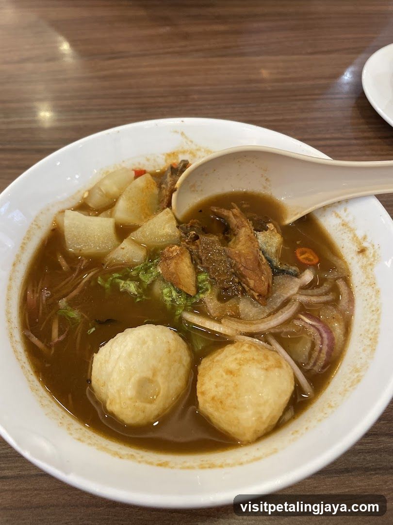Bowl of Soup with Meatballs and Vegetables