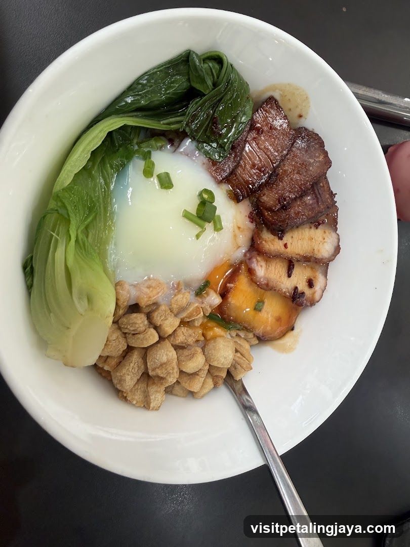 Bowl of food with egg, meat, and vegetables