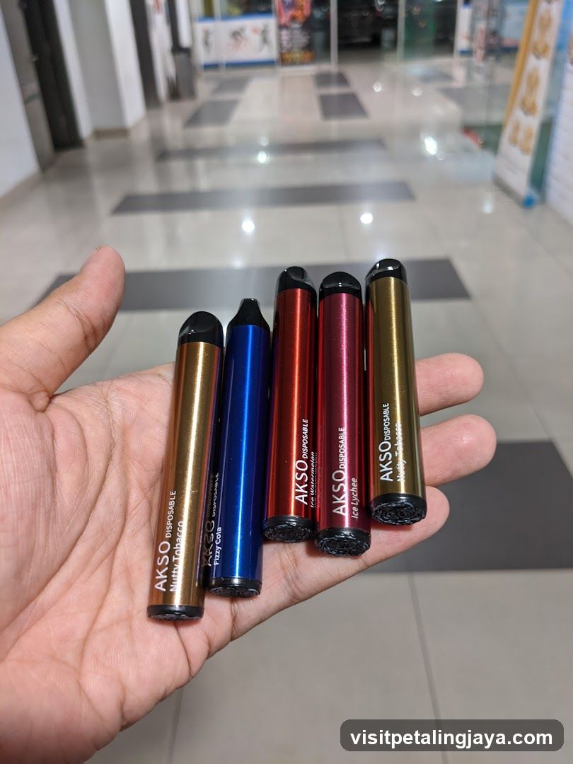 Hand holding disposable vapes